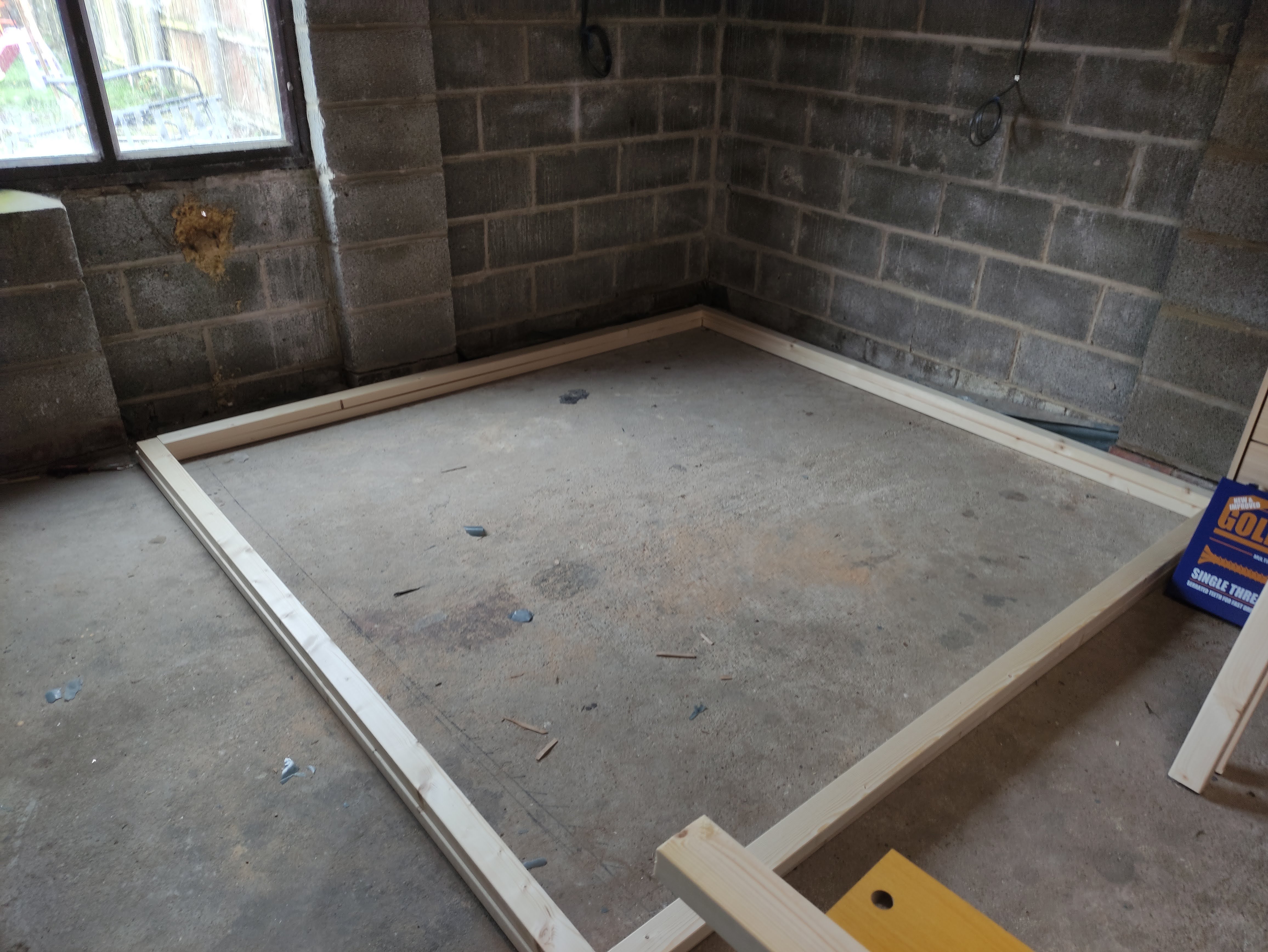 The timber for the office space layed on the ground in a square around showing the space that will be taken up